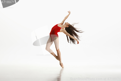 Image of Young graceful ballet dancer dancing on white studio background