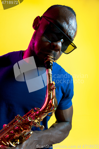 Image of Young african-american jazz musician playing the saxophone