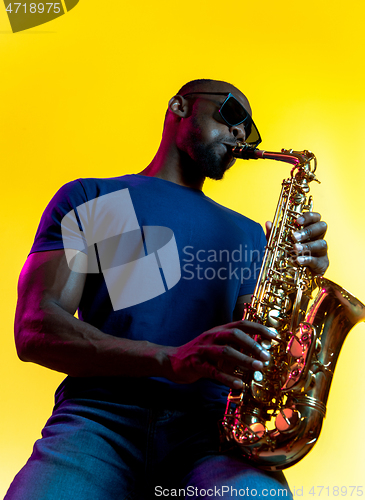 Image of Young african-american jazz musician playing the saxophone