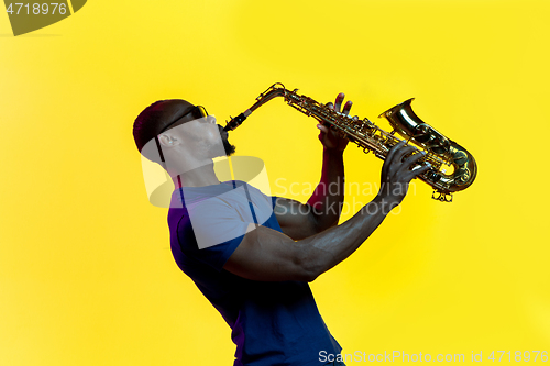 Image of Young african-american jazz musician playing the saxophone