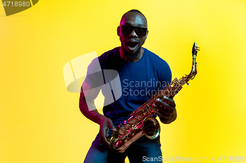 Image of Young african-american jazz musician playing the saxophone