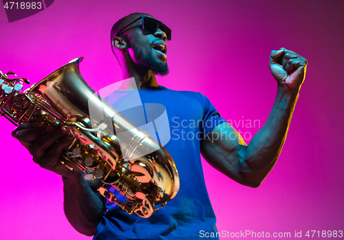 Image of Young african-american jazz musician playing the saxophone