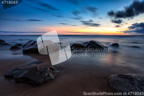 Image of Sea sunset seascape with wet rocks