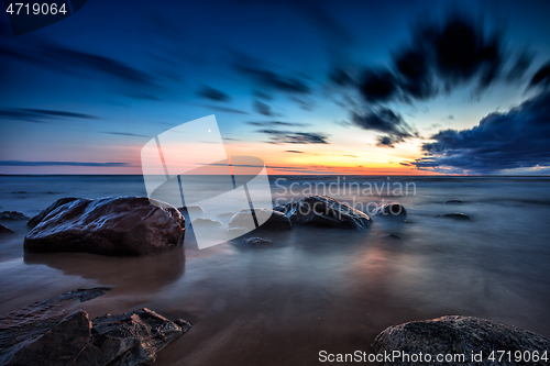 Image of Sea sunset seascape with wet rocks