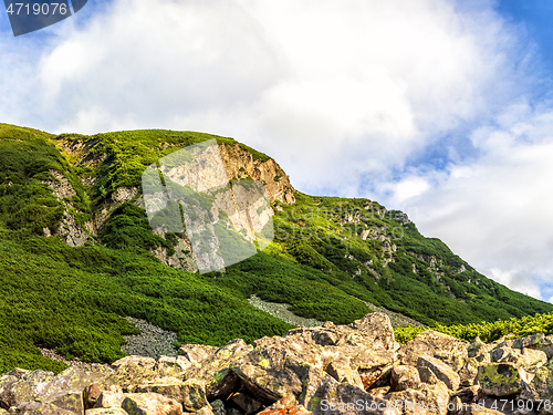 Image of Polish Tatra mountains summer landscape with blue sky and white clouds.