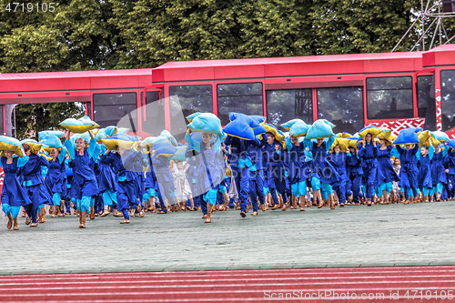 Image of Dancers in blue costumes perform at the Grand Folk dance concert
