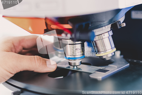 Image of Scientist microscoping on fluorescent microscope.