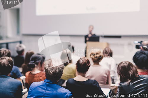 Image of Female speaker giving presentation on business conference.