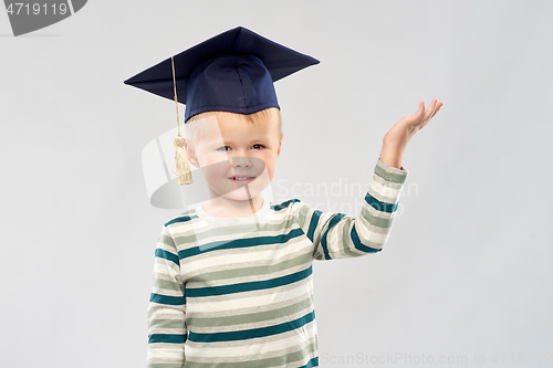 Image of little boy in mortar board with empty hand