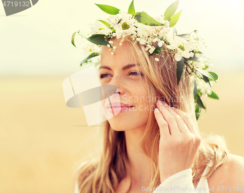 Image of happy woman in wreath of flowers