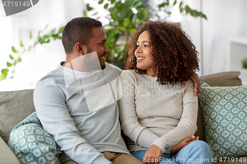 Image of african american couple on sofa talking at home