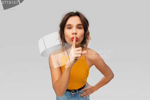 Image of young woman in mustard yellow top