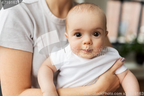 Image of close up of mother holding little baby daughter