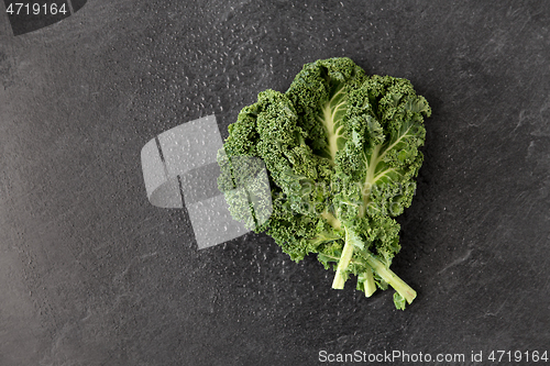 Image of close up of kale cabbage on slate background