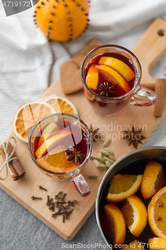 Image of pot with hot mulled wine, orange slices and spices