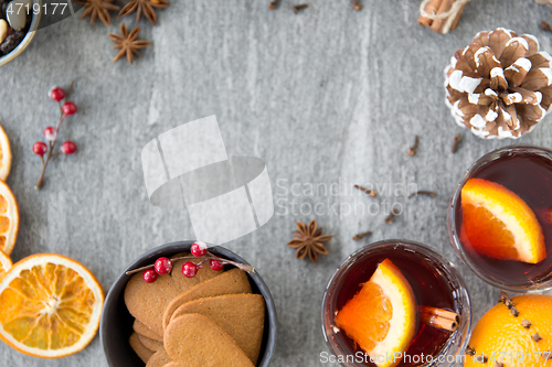 Image of hot mulled wine, orange slices, raisins and spices
