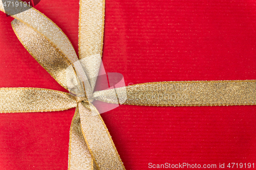 Image of close up of christmas red gift box with golden bow