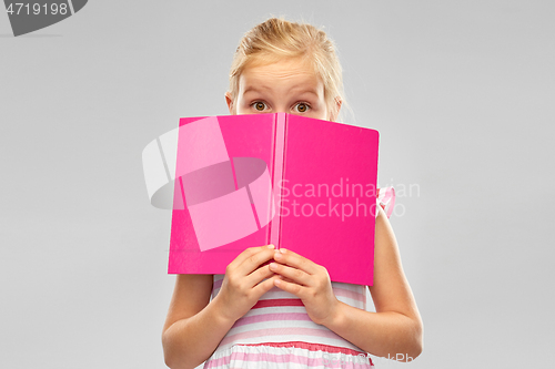Image of little girl hiding over book