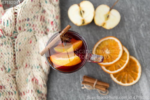 Image of glass of hot mulled wine with orange and cinnamon