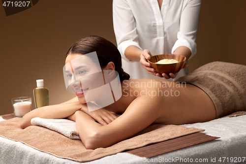 Image of woman and cosmetologist with mask in bowl at spa