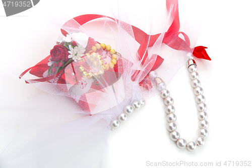 Image of pillow with golden beads bracelet rings 