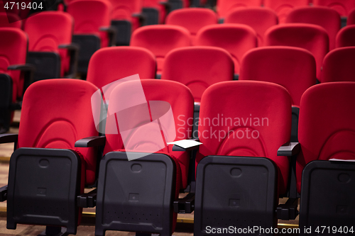 Image of hall with rows of red seats