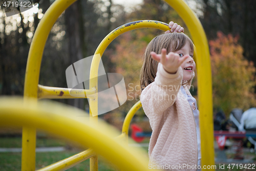 Image of cute little girl  having fun in playground