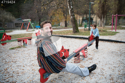 Image of father and  child having fun together  in park