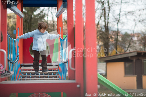 Image of cute little boy having fun in playground