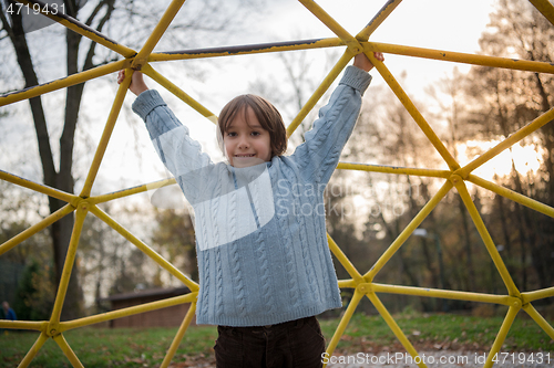 Image of cute little boy having fun in playground