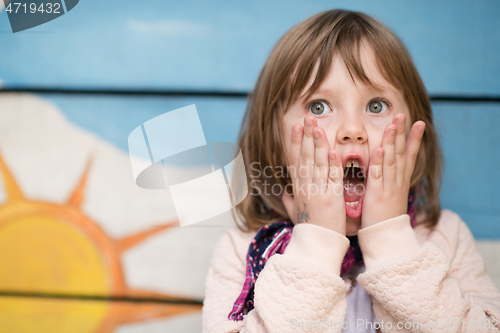 Image of cute little girl  having fun in playground