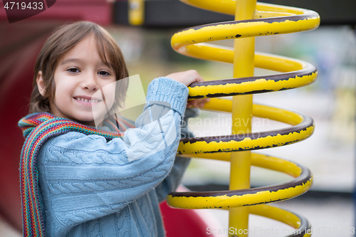 Image of cute little boy having fun in playground