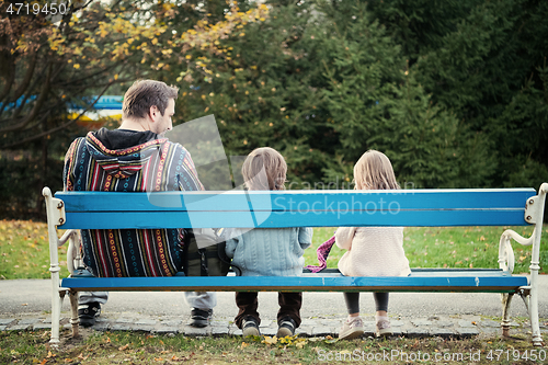 Image of father and  child having fun together  in park