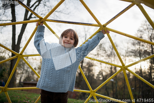 Image of cute little boy having fun in playground