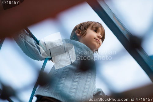 Image of cute little boy having fun in playground