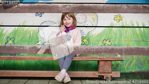 Image of cute little girl  having fun in playground