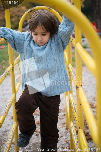 Image of cute little boy having fun in playground