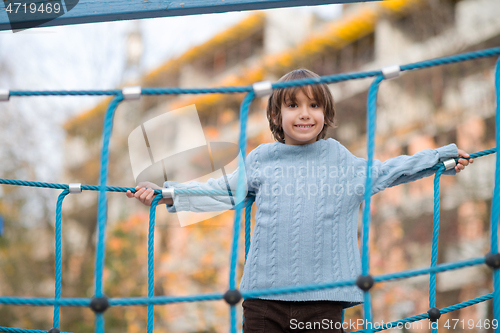 Image of cute little boy having fun in playground