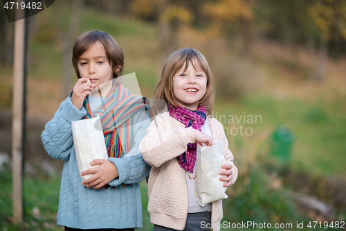 Image of kids in park eating popcorn in park