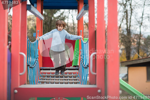 Image of cute little boy having fun in playground