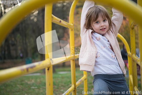 Image of cute little girl  having fun in playground