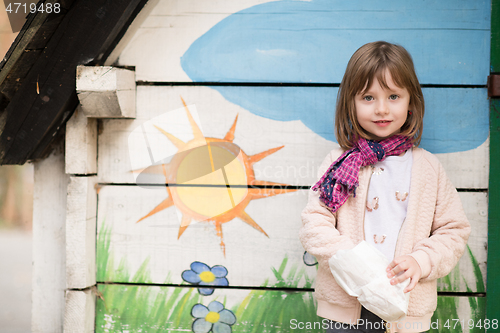 Image of cute little girl  having fun in playground