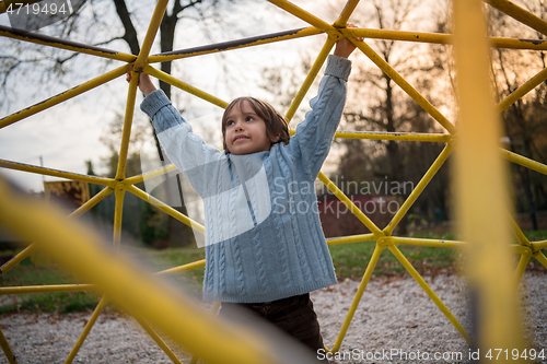 Image of cute little boy having fun in playground