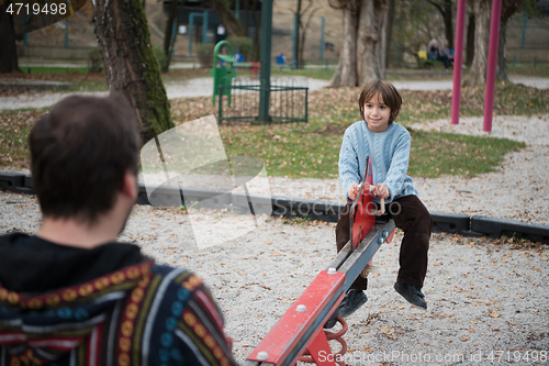 Image of father and  child having fun together  in park