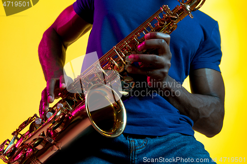 Image of Young african-american jazz musician playing the saxophone