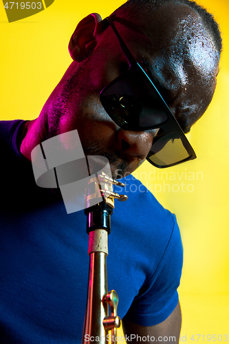 Image of Young african-american jazz musician playing the saxophone