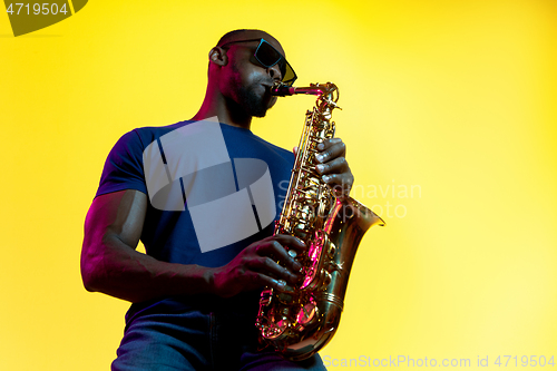 Image of Young african-american jazz musician playing the saxophone