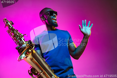 Image of Young african-american jazz musician playing the saxophone