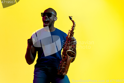 Image of Young african-american jazz musician playing the saxophone