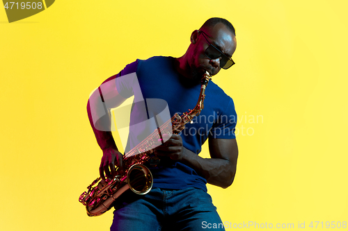 Image of Young african-american jazz musician playing the saxophone